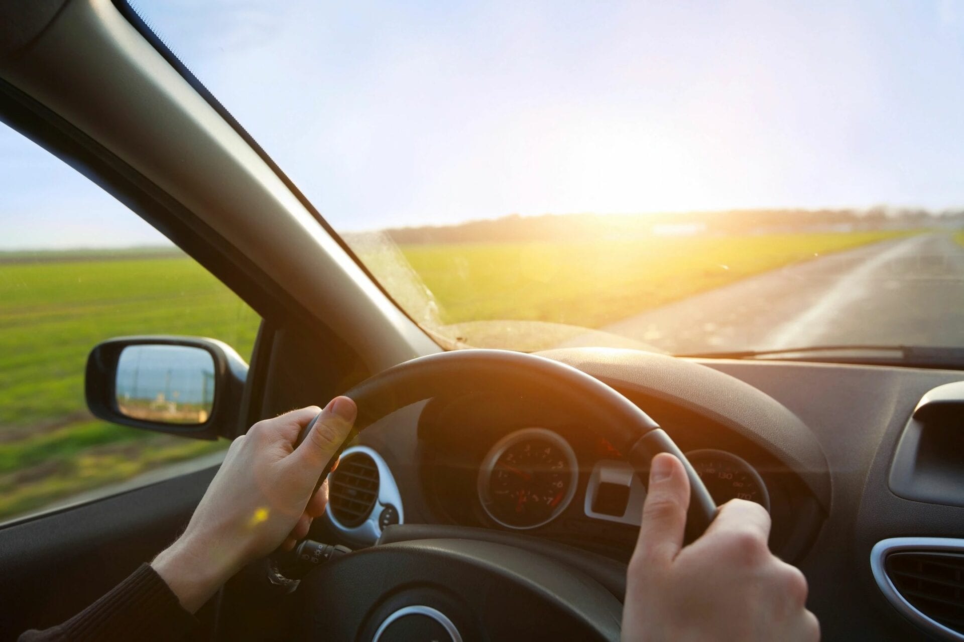 A person drives a well-aligned car on a sunny day